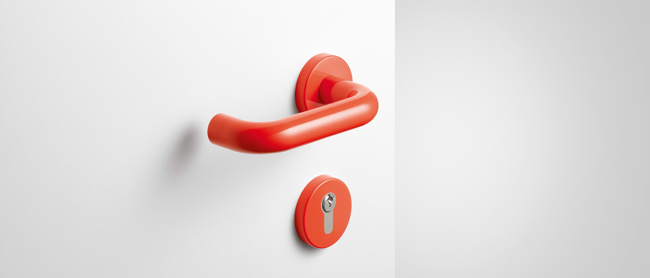 Lever handle with key rosette in the colour coral made of polyamide