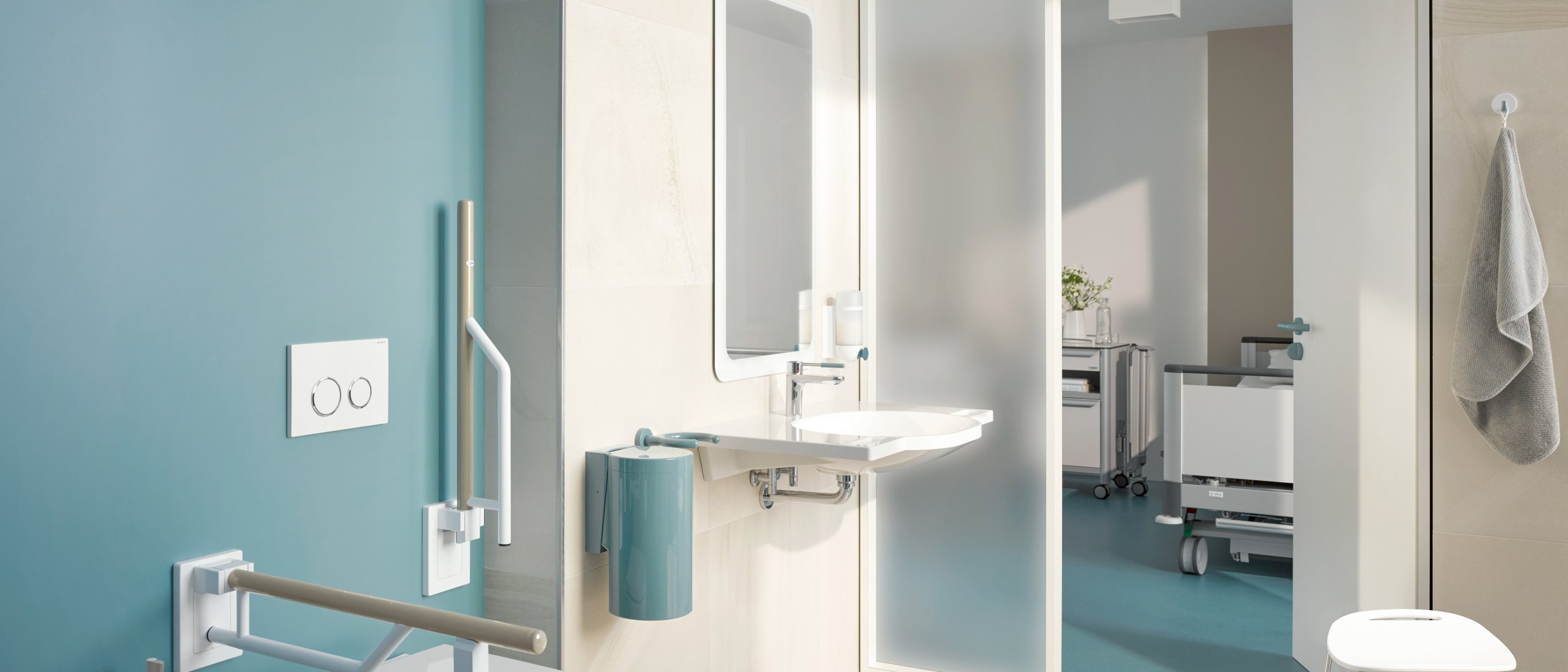 Barrier-free patient bathroom equipped with white and blue sanitary accessories