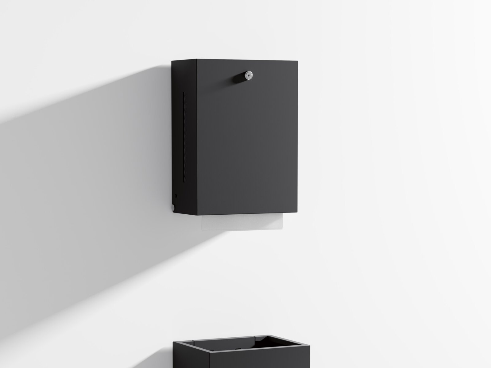 Paper towel dispenser and waste bin with angular design in matt black stainless steel